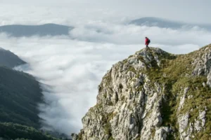 man standing on mountain edge